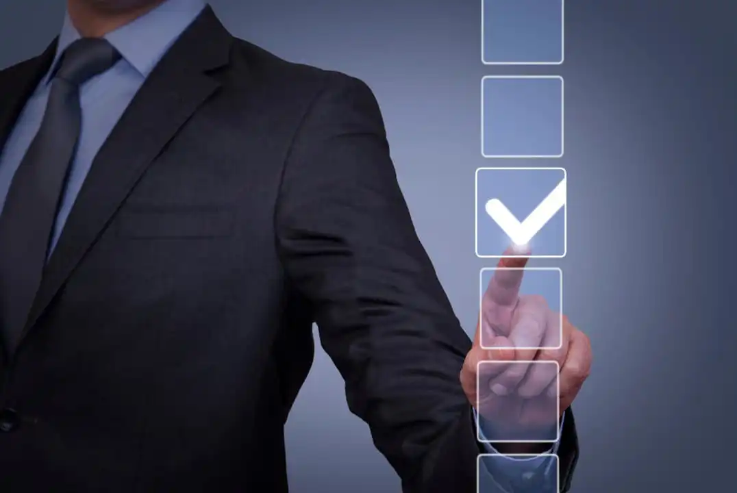 A businessman filling out a checklist for HR managers