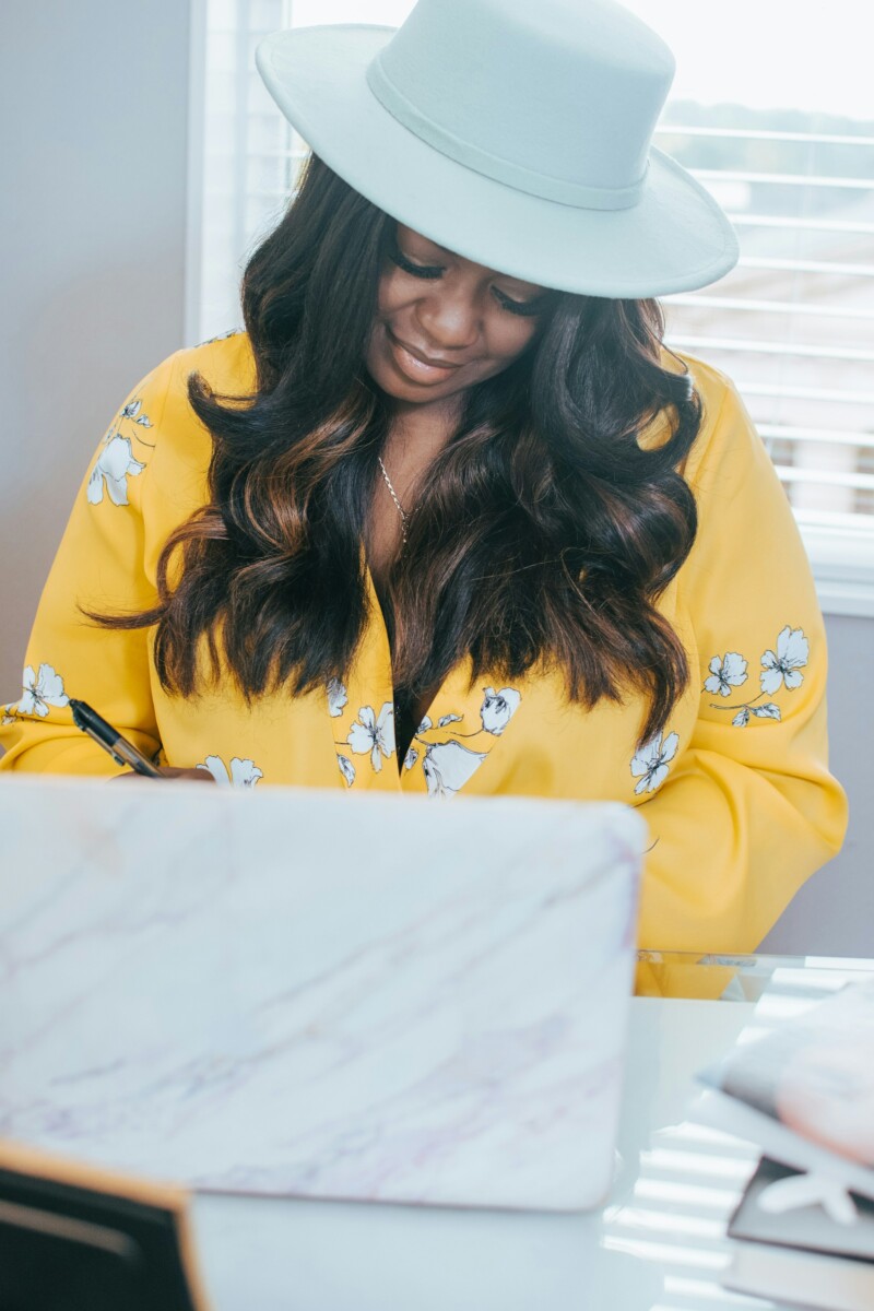 women smiling and looking at laptop