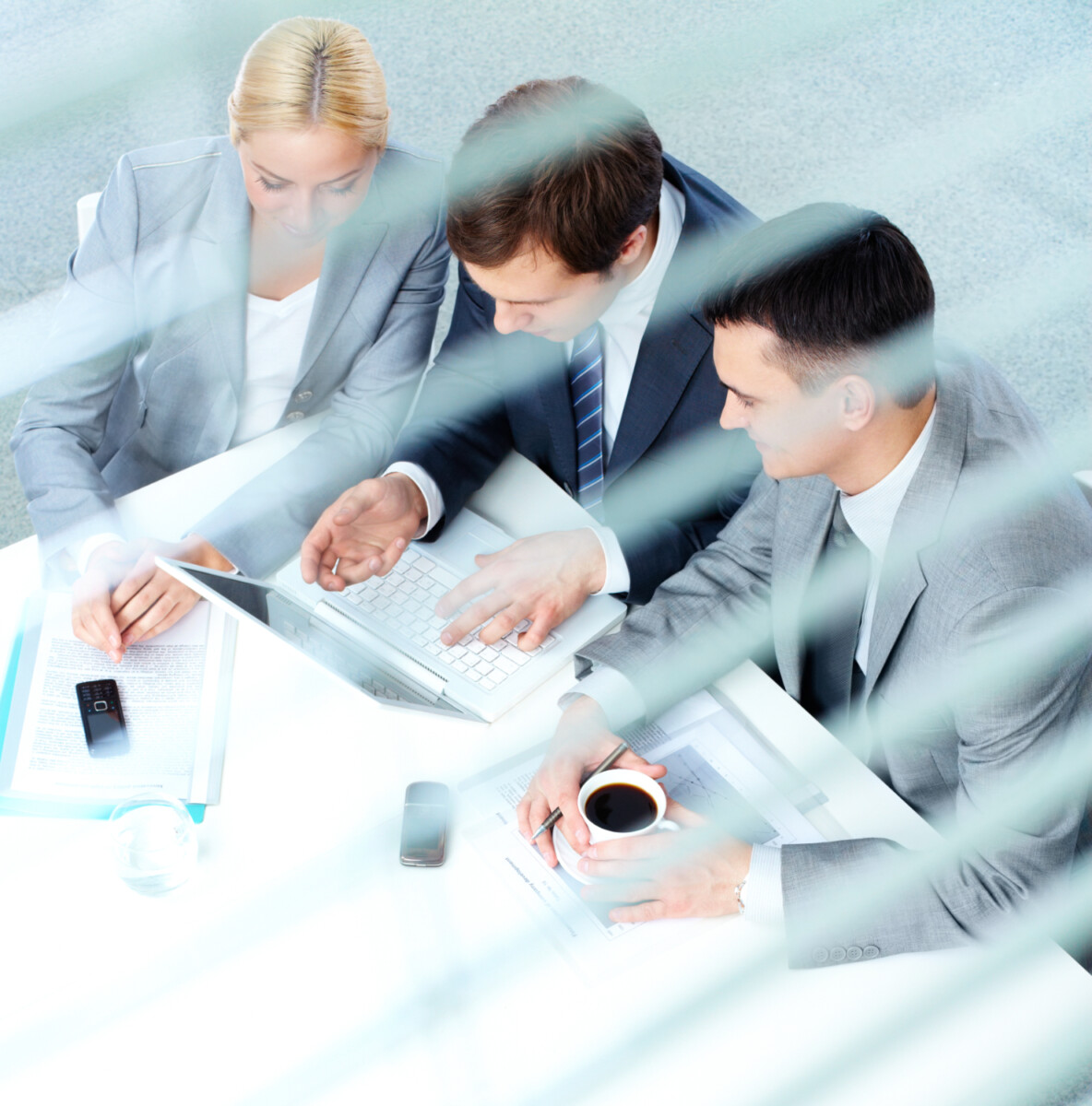 3 managers in front of laptop