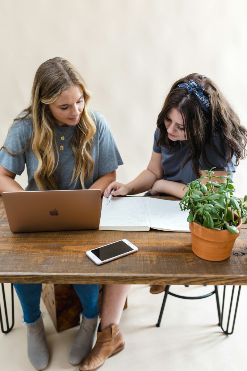 two women in front of laptop