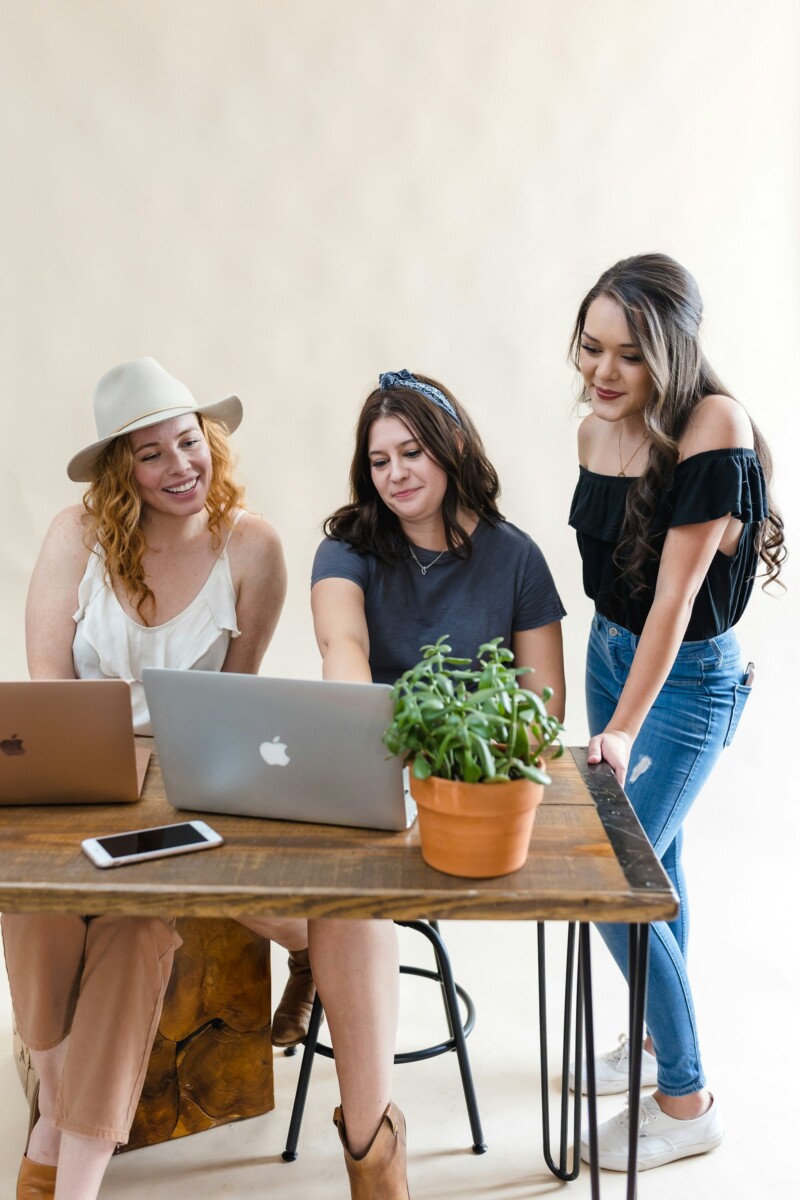 women sitting and watching laptop