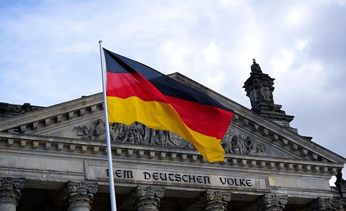 German flag flying in front of the Reichstag building in Berlin, Germany